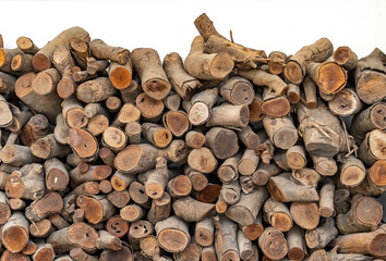 Stack of wood logs. Preparation of firewood for the winter.