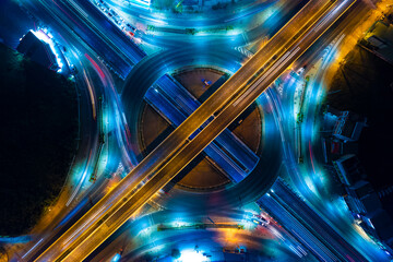 Expressway top view, Road traffic an important infrastructure,car traffic transportation above intersection road in city night, aerial view cityscape of advanced innovation, financial technology	