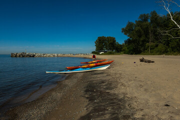 Fototapeta premium Kayaks beached in the early morning on Toronto's Centre Island. Shot in summer.