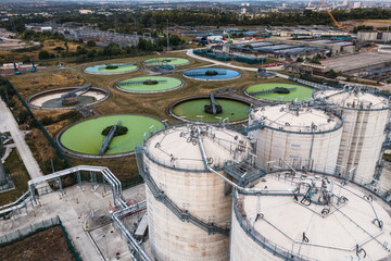Aerial view above waste water treatment plant with green algae