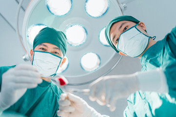 Low angle view, two Professional team confidence surgeon doctor performing surgery operation in...