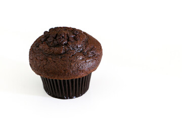 High angle shot of double chocolate muffin cake on the left, isolated by white background