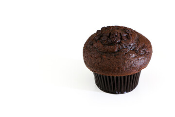 High angle shot of double chocolate muffin cake on the right, isolated by white background