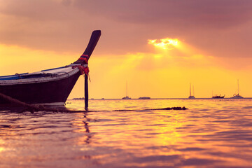 small boat at sunset