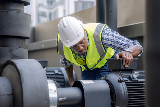 Engineer inspects a large industrial centrifugal pump.