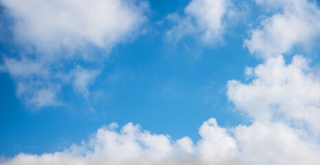sky background with fluffy clouds and blue space in the middle