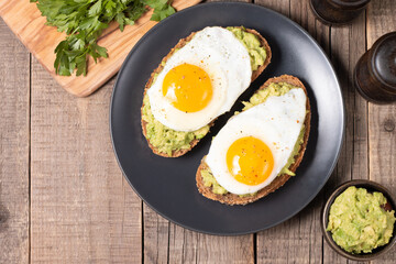 Two avocado open sandwiches with egg. Keto and diet concept. Healthy toast food for breakfast.