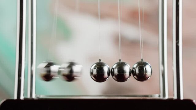 Newton balls close-up, five metallic pendulums colliding, cradle. Physics and science concept.