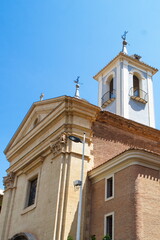 Fototapeta na wymiar Parish Church of Saint Lawrence in Murcia with facade, bell tower and dome on a sunny day