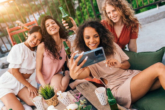 Multicultural girls take a selfie at the bachelorette party.