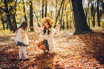 Cute and stylish family in a autumn park