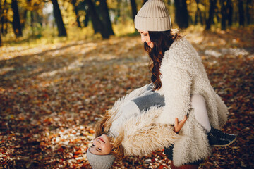 Cute and stylish family in a autumn park