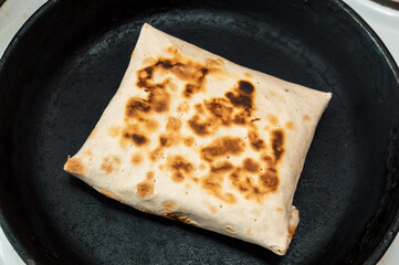 flatbread with filling in a frying pan