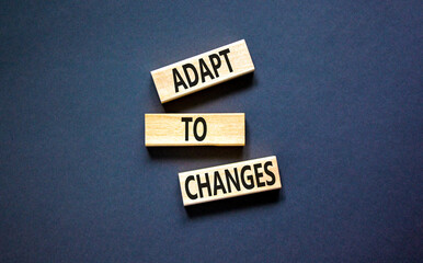 Adapt to changes symbol. Concept words Adapt to changes on wooden blocks. Beautiful black table...