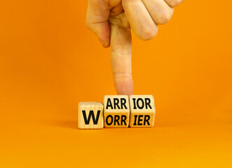 Be warrior not worrier symbol. Concept words Warrior and Worrier on wooden cubes. Businessman hand. Beautiful orange table orange background. Business and Be warrior not worrier concept. Copy space.