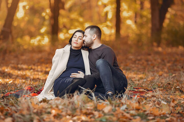 Beautiful couple spend time in a autumn park