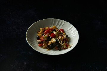 Mixed salad of eels, peppers, raisins, cheese, peas, cherry tomatoes and apple