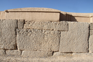 Close up photo of ancinet stone wall at ruins of Persepolis, Iran.