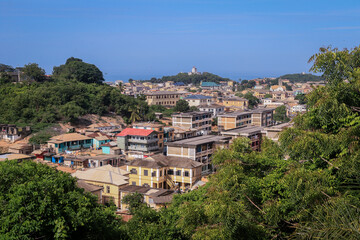 Fototapeta na wymiar Panoramic View to the Cape Coast Downtown Houses among Green Trees in Ghana, West Africa 