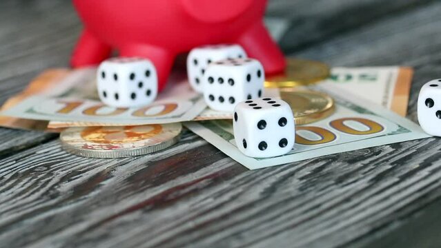 Piggy bank among dollar and euro banknotes. Cryptocurrency coins are visible. Multicurrency savings. Risk while saving money. Lowering the camera.