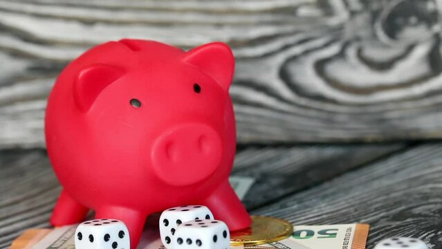 Piggy bank among dollar and euro banknotes. Cryptocurrency coins are visible. Multicurrency savings. Risk while saving money. Camera zoom._