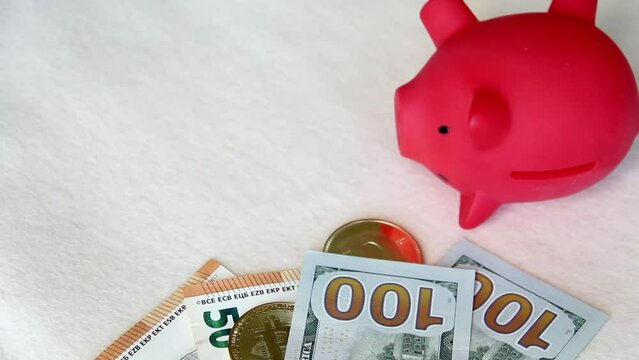 Piggy bank among dollar and euro banknotes. Cryptocurrency coins are visible. Multicurrency savings. Risk while saving money. On a white background