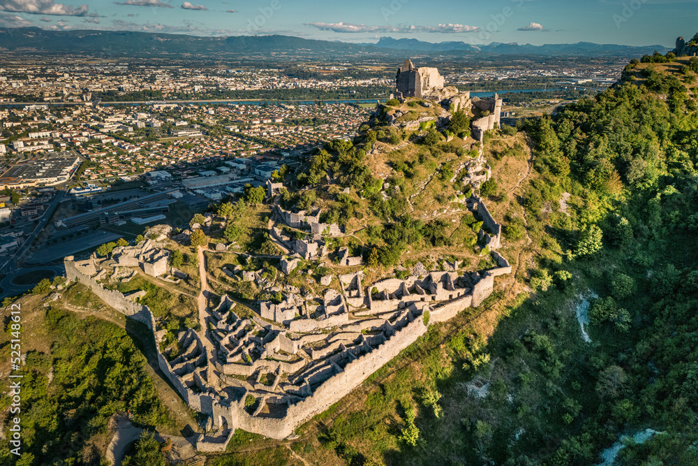 Wall mural Château de Crussol - is a mostly-ruined 12th century limestone castle in the commune of Saint-Péray that dominates the valley of Rhône, just opposite Valence in the Ardèche département, Rhône-Alpes 