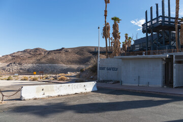 Spray painted sign at closed defunct Echo Bay Marina Lake Mead hotel reads boat safely over blocked...