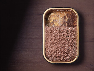 Partially eaten chocolate cake in aluminum foil tray