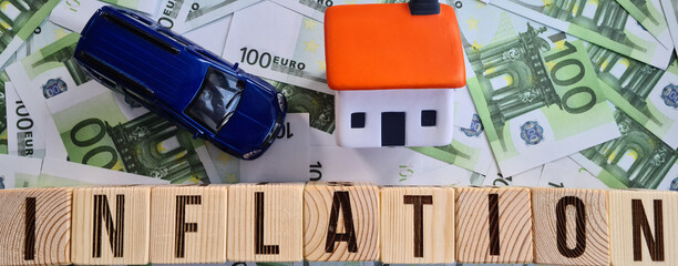 Inflation machine house and euro banknotes closeup