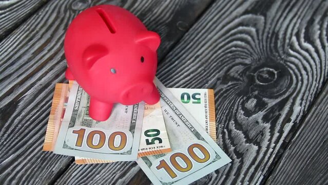 Piggy bank on dollar and euro banknotes. Next to the dice. Multicurrency savings. Risk while saving money..