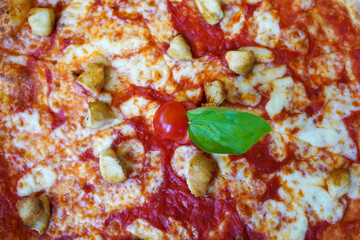 Italian pizza with cheese , tomato and meat on the table . Top view