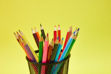 Colored pencils in the organizer. School and Education Template