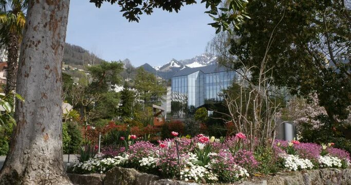 Montreux, Switzerland. Flower beds on the shores of Lake Geneva with the Stravinsky Auditorium in the background.