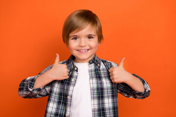 Photo of young cheerful boy show thumbs-up feedback perfect suggest isolated over orange color background
