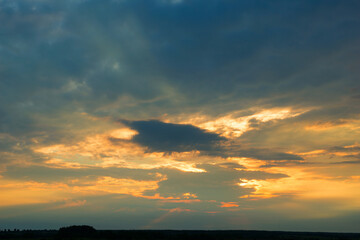 Naklejka na ściany i meble Bright dramatic sky with clouds at sunset