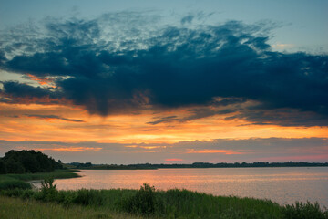 Obraz na płótnie Canvas Serene landscape with a lake lake in the evening