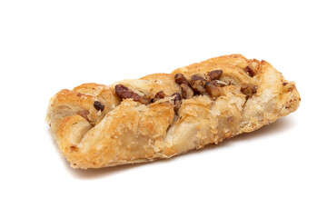 Sweet braided puff pastry isolated  on white background. Fresh phyllo pastry with jam inside and macadamia nuts close up.