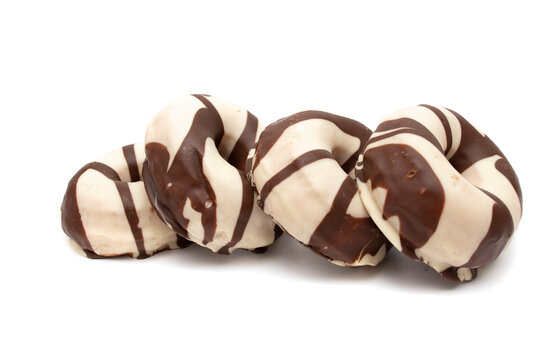 Donuts Covered With Chocolate And White Chocolate, Isolated In White Background. A Donut Has Approximately 300 Calories And 25 G Of Fat On Average.