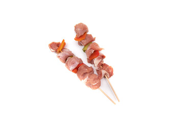 Raw meat and vegetable skewer, isolated on white background. In gastronomy, brochette (from the...