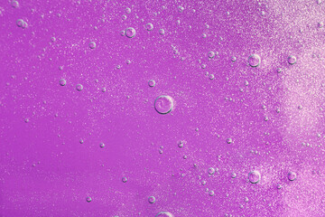 Macro photography of bubbly smear on purple background.