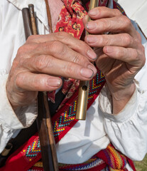hands playing antique penny whistle