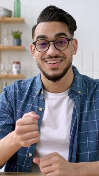 Vertical video of friendly indian or arabian man, business leader or coach, conducts business meeting with colleagues, holds a speech of ideas and promotion, talks about strategy,records online lesson