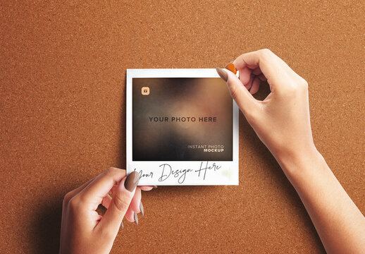 Hand Pinning Instant Photo on a Board Mockup