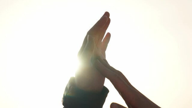 hands couple a close-up. hands men and women symbol love teamwork. silhouette hands support stroking each other close-up. happy family together teamwork sunlight