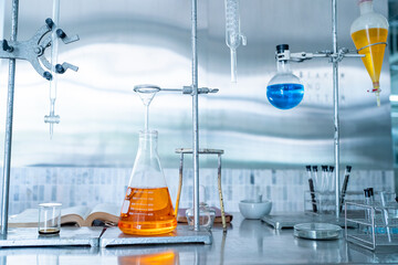 scientist doing research on plants holding a green solution in a test tube