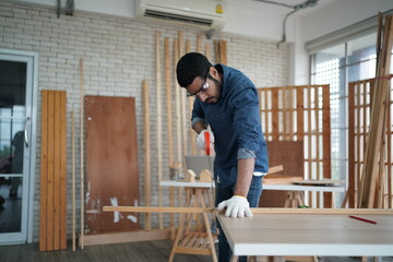 Carpenter or warehouse worker choosing raw wood material for the work at the carpentry storage