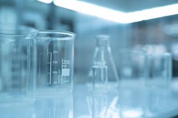 scientist doing research on plants holding a green solution in a test tube