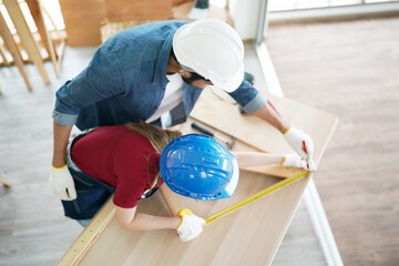 Carpenter or warehouse worker choosing raw wood material for the work at the carpentry storage