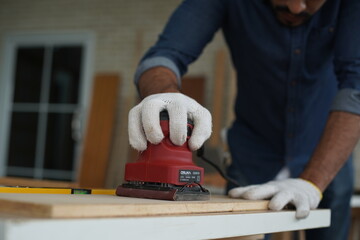 Carpenter or warehouse worker choosing raw wood material for the work at the carpentry storage